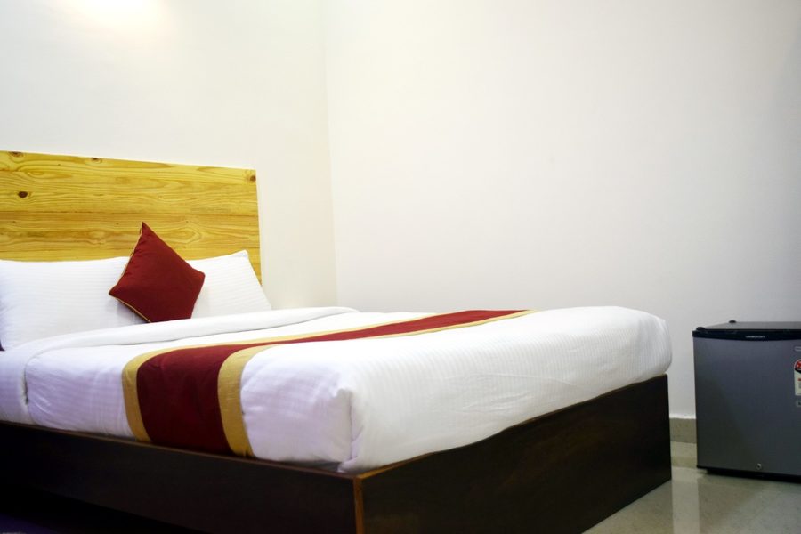Comfortable double room with crisp white linen and mini fridge