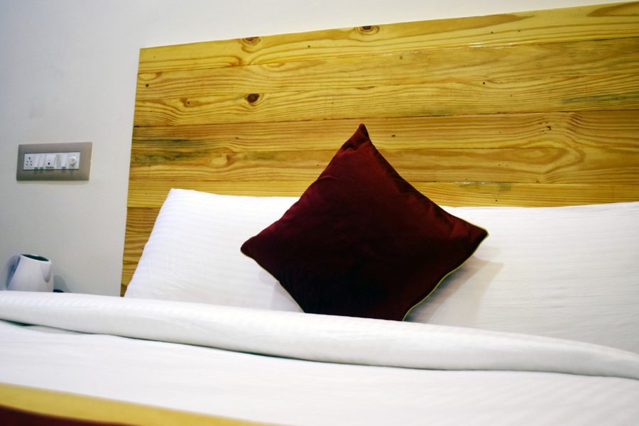 Room with wooden headboard and TV — Bandipur Hill View Homestay